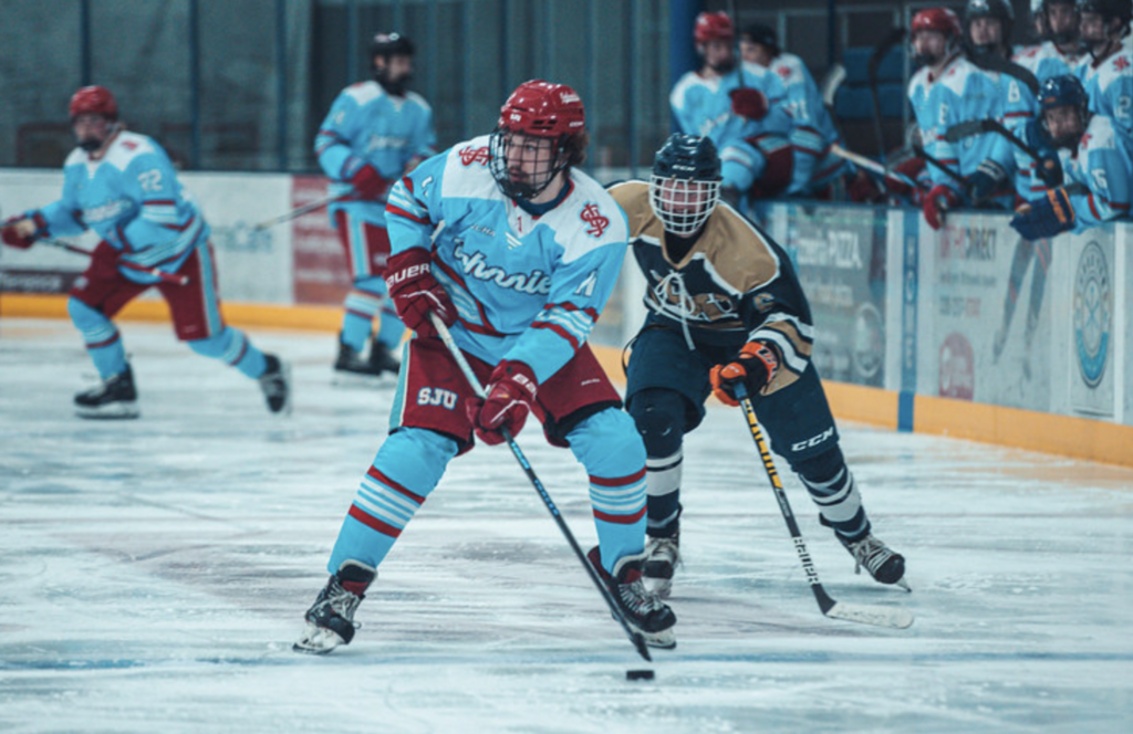 Saint John's University hockey player wearing their alternate jersey designed by Akros Athletic