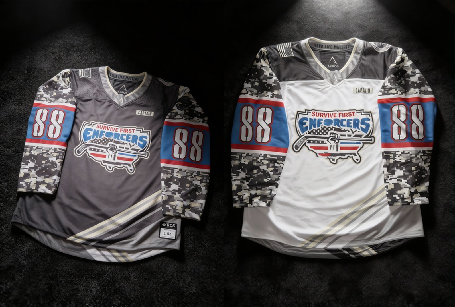 Two Survive First Enforcers hockey jerseys made by Akros Athletic are displayed on a concrete floor